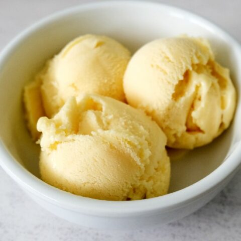 3 scoops of pineapple ice cream in a white bowl