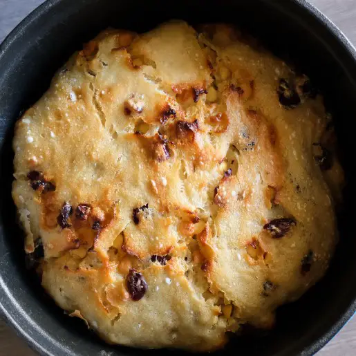 loaf of white chocolate cranberry bread in a dutch oven