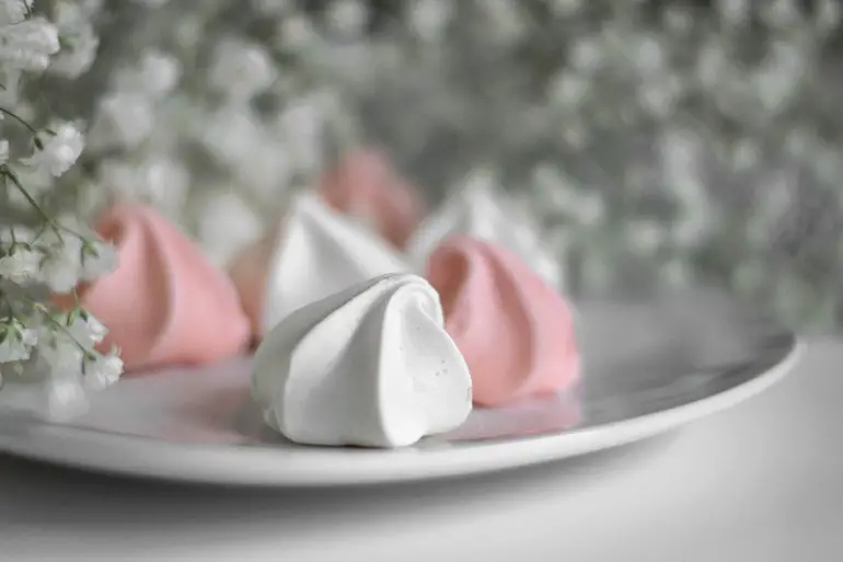 pink and white meringues on a white plate