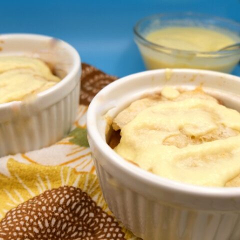 close up of peach cobbler topped with creme anglaise