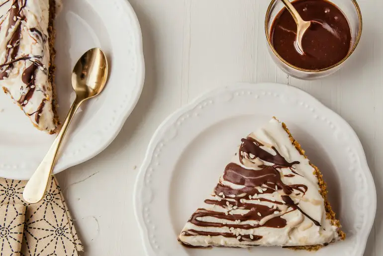 pie on a white plate with a chocolate drizzle