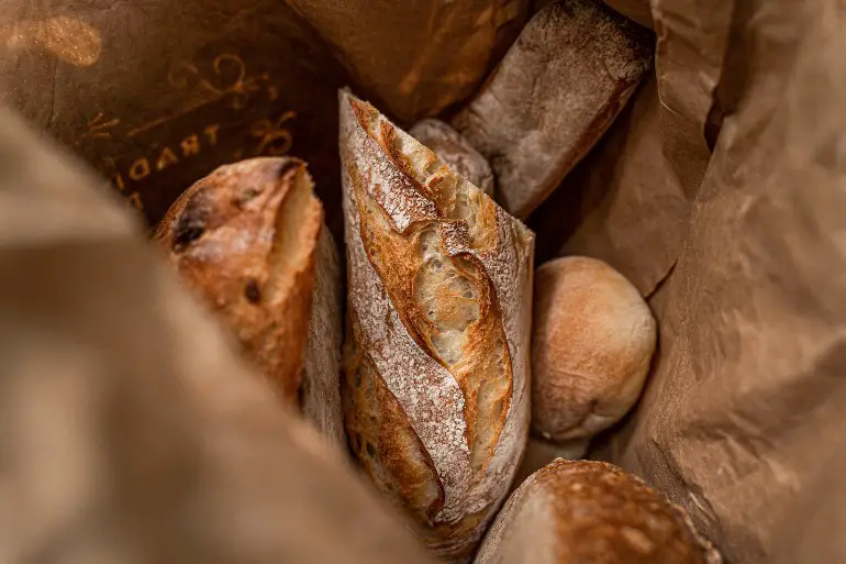 several loaves of bread in a paper bag