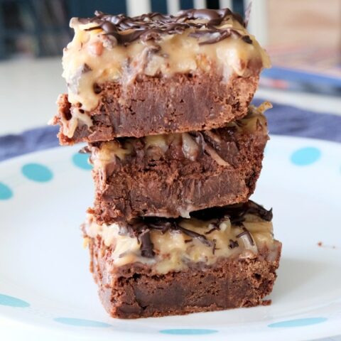 three brownies stacked on a blue and white plate