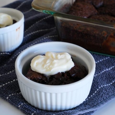 ramekin of pudding cake with whipped cream on top