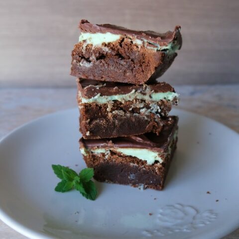 3 mint brownies stacked on a white plate