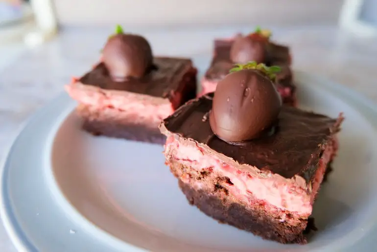 3 chocolate strawberry brownies on a white plate