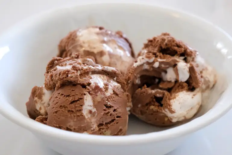 3 scoops of rocky road ice cream in a white bowl