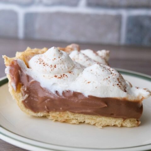 slice of pudding pie topped with whipped cream