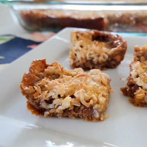 3 hello dolly bars arranged on a white plate